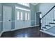 Home foyer featuring grand doors, hardwood floors and staircase at 1810 Talbot Ct, Lawrenceville, GA 30044