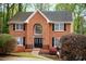 Brick facade home featuring large front window and black shutters surrounded by lush landscaping at 1810 Talbot Ct, Lawrenceville, GA 30044