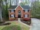 Charming brick home featuring a landscaped front yard and black-shuttered windows at 1810 Talbot Ct, Lawrenceville, GA 30044