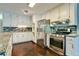 Well-equipped kitchen with stainless steel appliances, granite counters, and white cabinetry at 1810 Talbot Ct, Lawrenceville, GA 30044