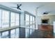 Sunlit living area with hardwood floors, adjacent to a cozy fireplace at 1810 Talbot Ct, Lawrenceville, GA 30044