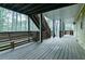 Wide covered wooden porch with stairs to the yard and access to the home at 1810 Talbot Ct, Lawrenceville, GA 30044