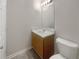 Bathroom featuring a modern vanity, mirror, toilet, and tile flooring at 7302 Par Four Way, Lithonia, GA 30038