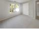 Bright bedroom with a large window, neutral walls and carpeting, and ample natural light at 7302 Par Four Way, Lithonia, GA 30038