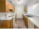 Functional kitchen with wooden cabinetry, modern appliances, and ample counter space, ideal for preparing delicious meals at 7302 Par Four Way, Lithonia, GA 30038