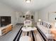Bright living room with plush rug, white furniture, and modern decor at 7302 Par Four Way, Lithonia, GA 30038