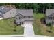 Aerial view of a two-story home with a well-maintained lawn and a paved driveway at 485 Auburn Crossing Dr, Auburn, GA 30011