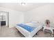 The bedroom features neutral carpet, a bed and easy access to the full bathroom at 485 Auburn Crossing Dr, Auburn, GA 30011