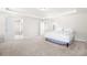 Carpeted bedroom with neutral walls and a tray ceiling provides a blank canvas at 485 Auburn Crossing Dr, Auburn, GA 30011