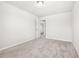 An empty bedroom features neutral carpet, a ceiling light and easy access to the hallway at 485 Auburn Crossing Dr, Auburn, GA 30011