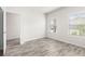 A bright bedroom boasts luxury vinyl plank flooring and natural light streaming in from the windows at 485 Auburn Crossing Dr, Auburn, GA 30011
