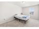 A bedroom includes neutral carpet, a single bed and a window providing ample natural light at 485 Auburn Crossing Dr, Auburn, GA 30011