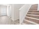 Bright entryway with a staircase, wood-look flooring and a white door leading to the outside at 485 Auburn Crossing Dr, Auburn, GA 30011