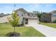 Inviting two-story home with a well-maintained lawn and a paved driveway, surrounded by lush greenery at 485 Auburn Crossing Dr, Auburn, GA 30011