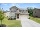 Attractive two-story home with a neat front lawn and a driveway leading to an attached two-car garage at 485 Auburn Crossing Dr, Auburn, GA 30011