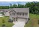 Well-maintained two-story home featuring a paved driveway, a two-car garage, and a green lawn at 485 Auburn Crossing Dr, Auburn, GA 30011