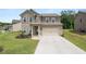Charming two-story home with a well-manicured lawn and a two-car garage in a suburban neighborhood at 485 Auburn Crossing Dr, Auburn, GA 30011