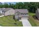 Well-kept two-story home with a green lawn, a paved driveway, and an attached two-car garage at 485 Auburn Crossing Dr, Auburn, GA 30011