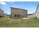 Back of a home with a patio and well-maintained lawn in a residential area at 485 Auburn Crossing Dr, Auburn, GA 30011
