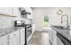Well-equipped kitchen boasts granite countertops, stainless steel appliances, and white cabinetry at 485 Auburn Crossing Dr, Auburn, GA 30011
