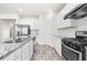 Spacious kitchen showcases granite countertops, stainless steel appliances, and ample cabinet space at 485 Auburn Crossing Dr, Auburn, GA 30011