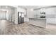 Bright kitchen with white cabinets, stainless steel appliances, and a large island with a marble countertop at 485 Auburn Crossing Dr, Auburn, GA 30011