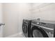 This laundry room includes modern, front-loading Samsung washer and dryer at 485 Auburn Crossing Dr, Auburn, GA 30011