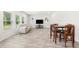 Open-concept living area with a sofa, dining table, and large windows offering ample natural light at 485 Auburn Crossing Dr, Auburn, GA 30011