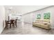 Sunlit open-concept with a dining table and comfortable sofa at 485 Auburn Crossing Dr, Auburn, GA 30011