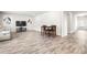 Spacious living room with wood-look floors and a dining area at 485 Auburn Crossing Dr, Auburn, GA 30011
