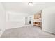 The upstairs loft space offers a large open area with carpet and easy access to the laundry room at 485 Auburn Crossing Dr, Auburn, GA 30011