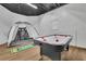 Finished basement featuring a sleek air hockey table and indoor golf practice setup at 1025 Saint Marks Walk, Suwanee, GA 30024