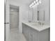 Modern bathroom with double sinks, vanity, and a separate glass-enclosed shower with tile surround at 1025 Saint Marks Walk, Suwanee, GA 30024