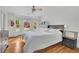 Well-lit bedroom with hardwood floors, a ceiling fan, dresser, and large windows at 1025 Saint Marks Walk, Suwanee, GA 30024