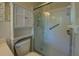 All-white bathroom with a glass-enclosed shower and grab bar at 1283 Maple St, Conyers, GA 30013