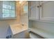 Bright white bathroom with a vanity, built-in cabinet, and sink at 1283 Maple St, Conyers, GA 30013
