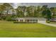 Charming one-story brick home with manicured lawn and tasteful landscaping and black shutters at 1283 Maple St, Conyers, GA 30013