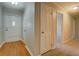 Inviting foyer with hardwood floors and neutral paint, leading to carpeted hallway at 1283 Maple St, Conyers, GA 30013