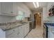 Bright kitchen featuring white cabinets, stainless steel appliances, and tile backsplash at 1283 Maple St, Conyers, GA 30013