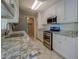 Kitchen with granite countertops, stainless steel appliances, and white cabinetry at 1283 Maple St, Conyers, GA 30013