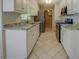 Galley kitchen with granite countertops and stainless steel appliances and a white tile floor at 1283 Maple St, Conyers, GA 30013
