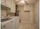 Neat laundry space featuring full size washer and dryer, along with storage cabinets at 1283 Maple St, Conyers, GA 30013