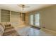 Bright living space with tile flooring, built-in shelving, and direct access to the patio through double doors at 1283 Maple St, Conyers, GA 30013