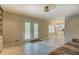 Bright living room featuring tile floors, ceiling fan, and doors leading to the outdoor patio at 1283 Maple St, Conyers, GA 30013
