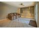 Spacious living area with neutral walls, tile flooring, and built-in shelving for storage and display at 1283 Maple St, Conyers, GA 30013