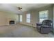 Spacious living room featuring a cozy fireplace and comfortable armchair at 1283 Maple St, Conyers, GA 30013