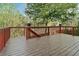 Spacious back deck with wood railing and floorboards offering a picturesque view of surrounding lush greenery at 1610 Apollo Dr, Suwanee, GA 30024