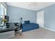 Bedroom featuring a desk, chair, daybed, carpeted floors, light blue walls, and natural light from a window at 1610 Apollo Dr, Suwanee, GA 30024