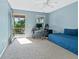 Bedroom with door to balcony, featuring a desk, office chair, daybed, and view of lush greenery at 1610 Apollo Dr, Suwanee, GA 30024