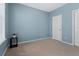 Cozy bedroom with carpet flooring, light blue walls, a window and a white closet door at 1610 Apollo Dr, Suwanee, GA 30024